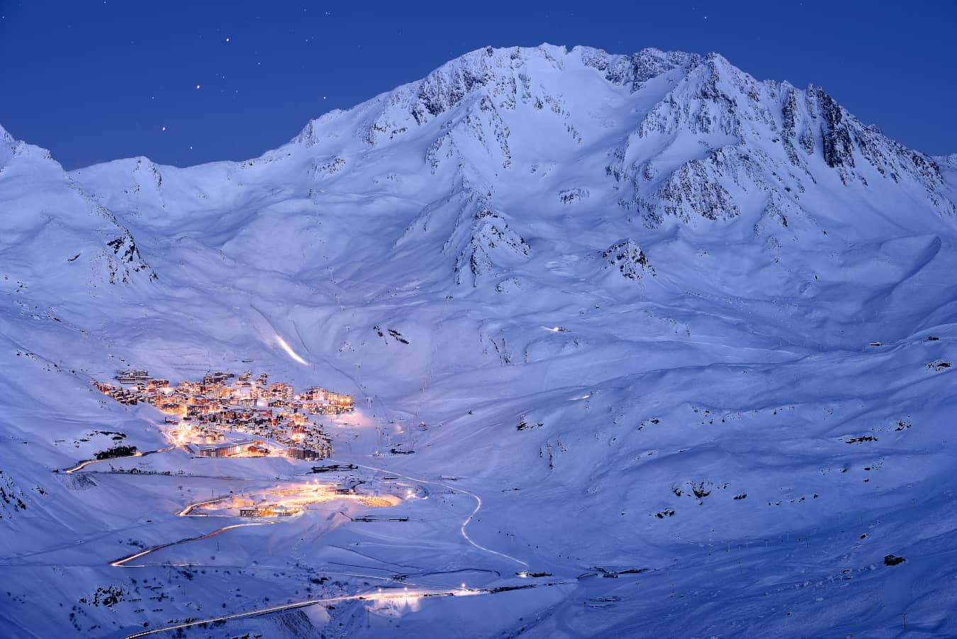 Val Thorens, located in Les 3 Vallées, at night with the piste groomers
