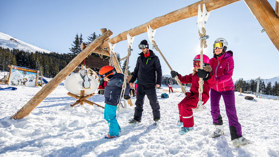 Family playing in a playground in Méribel at the heart of Les 3 Vallées